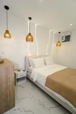 a bedroom with a bed with lights on the wall at Athens City-Break Studios- near Acropolis in Athens