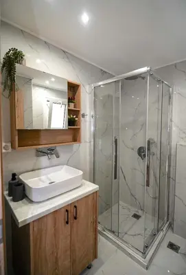 a bathroom with a sink and a shower at Athens City-Break Studios- near Acropolis in Athens