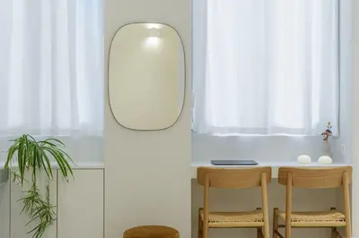a small table with two chairs and a mirror at Ivory - Studio in Thisseio in Athens