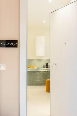 a glass door with a kitchen in the background at Ivory - Studio in Thisseio in Athens