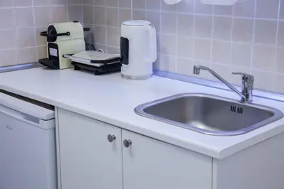 a kitchen counter with a sink and a appliance at Modern Studio Stay in Trendy Kolonaki in Athens