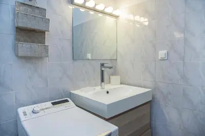 a white bathroom with a sink and a mirror at Modern Studio Stay in Trendy Kolonaki in Athens
