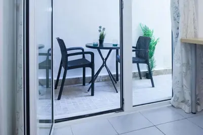 a table and chairs in a room with a window at Modern Studio Stay in Trendy Kolonaki in Athens