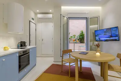 a kitchen and dining room with a table and a dining room at Ciel - Studio in Thisseio in Athens