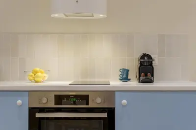 a kitchen with a stove and a bowl of lemons at Ciel - Studio in Thisseio in Athens