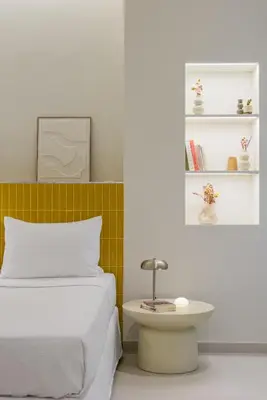a bedroom with a bed and a table and shelves at Ciel - Studio in Thisseio in Athens