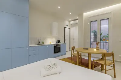 a kitchen with a table and a dining room at Ciel - Studio in Thisseio in Athens