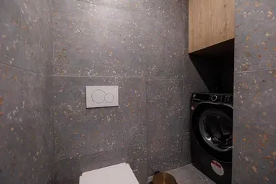 a bathroom with a toilet and a washing machine at Luxurious Apartment at Hilton Area in Athens