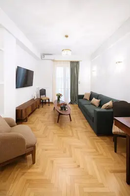 a living room with a couch and a table at Luxurious Apartment at Hilton Area in Athens