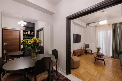 a living room and a dining room with a table and a living room at Luxurious Apartment at Hilton Area in Athens