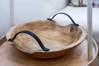 a wooden bowl sitting on top of a table at Lilly's House in Athens
