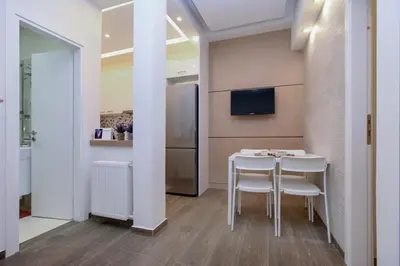 a kitchen with a table and chairs and a refrigerator at Lilly's House in Athens