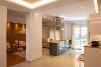 a kitchen with a counter and a living room at E35 by SpitiSou in Athens