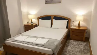 a bedroom with a large bed with two night stands at The Exarcheia Nook Chic Renovated 2BR Apartment in Athens