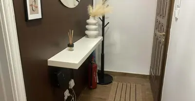 a bathroom with a white sink and a vase on a table at The Exarcheia Nook Chic Renovated 2BR Apartment in Athens