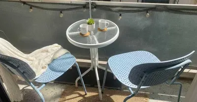 a small table with two chairs and two cups on it at The Exarcheia Nook Chic Renovated 2BR Apartment in Athens