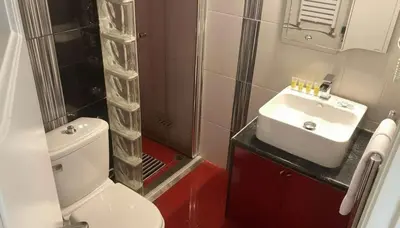 a bathroom with a toilet and a sink and a shower at The Exarcheia Nook Chic Renovated 2BR Apartment in Athens