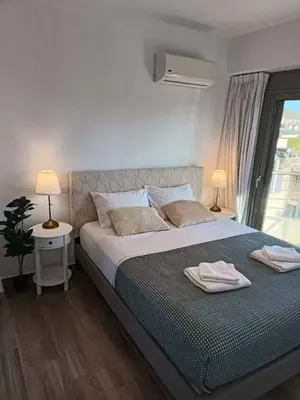 a bedroom with a bed with two towels on it at My Seaview & Beach home in Athens