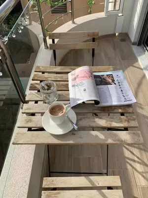a table with a cup of coffee and a newspaper at My Seaview & Beach home in Athens