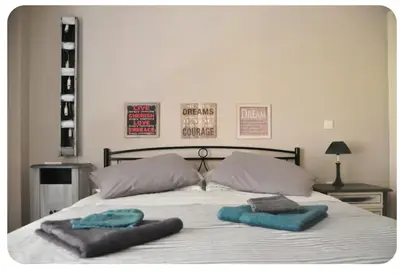two towels on a bed with two pillows on it at Kornilis apartment near the historical center in Athens