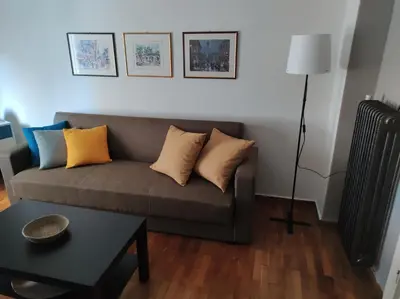 a living room with a couch and a table at Kornilis apartment near the historical center in Athens