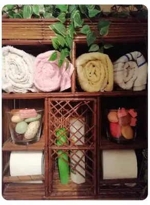 a wooden shelf filled with different types of towels at Kornilis apartment near the historical center in Athens