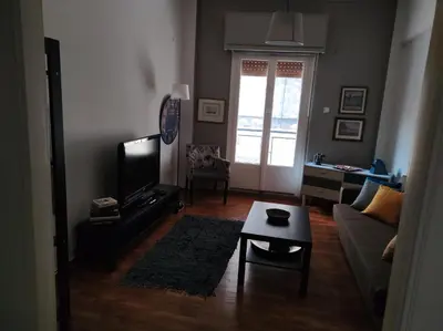 a living room with a couch and a table at Kornilis apartment near the historical center in Athens