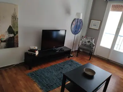 a living room with a flat screen tv and a table at Kornilis apartment near the historical center in Athens
