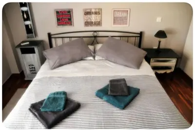 a bed with two towels and two pillows on it at Kornilis apartment near the historical center in Athens