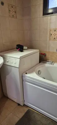 a bathroom with a tub and a toilet and a sink at FarmHouse near Airport in Paianía