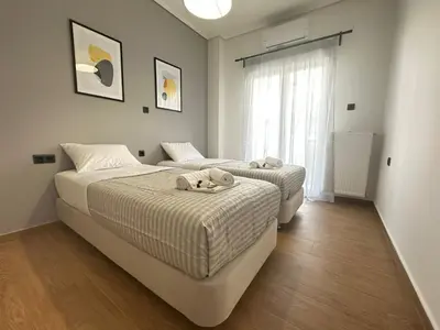 two beds in a bedroom with a window at 4th Floor Bright 2BR Retreat Near Acropolis in Athens