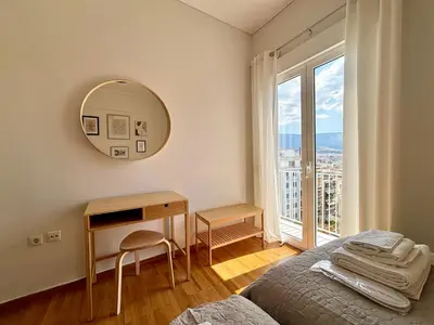 a bedroom with a mirror and a bed and a desk at Cozy apartment in Kolonaki in Athens