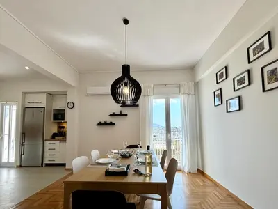 a kitchen and dining room with a table and chairs at Cozy apartment in Kolonaki in Athens