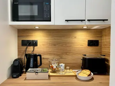 a kitchen with a counter top with a microwave at Cozy apartment in Kolonaki in Athens