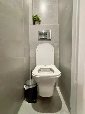 a bathroom with a white toilet in a stall at Cozy apartment in Kolonaki in Athens