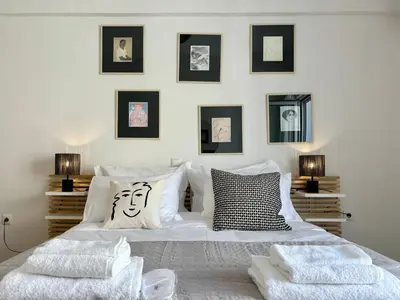 a bedroom with a large white bed with two pillows at Cozy apartment in Kolonaki in Athens