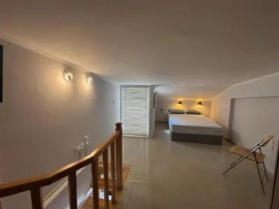 a bedroom with a bed in a room with a staircase at mets in Athens