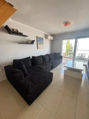 a living room with a black couch and a table at mets in Athens