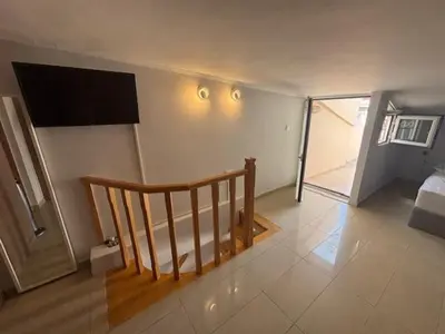 a room with a staircase and a room with a bed at mets in Athens