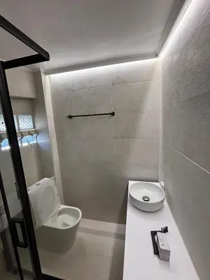a white bathroom with a toilet and a sink at mets in Athens