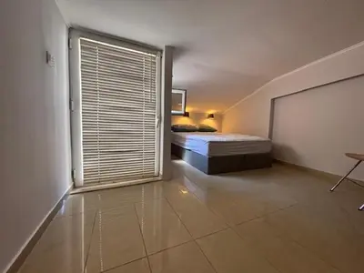 a bedroom with a bed and a large window at mets in Athens
