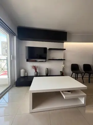 a living room with a white table and chairs at mets in Athens