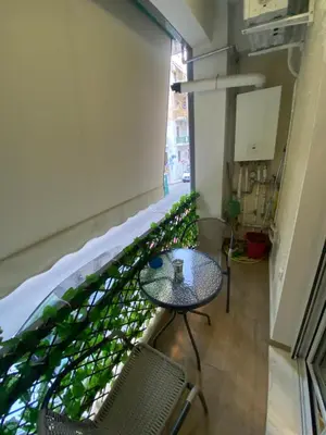 a room with a table and chairs in a building at Golden Nest Apartment in Athens