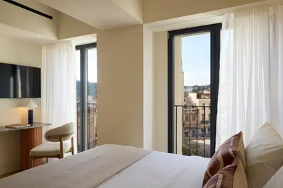 a bedroom with a bed and a large window at Bellén Athens Ηotel in Athens