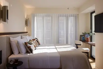 a bedroom with a large white bed and a window at Bellén Athens Ηotel in Athens