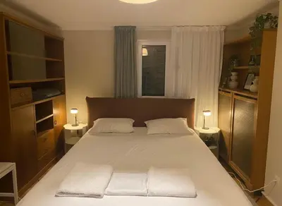 a bedroom with a large bed with two white pillows at Acropolis Vista 3-Bedroom in Neos Kosmos in Athens