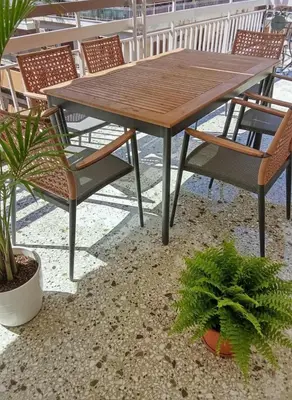a wooden table and chairs and plants on a patio at Acropolis Vista 3-Bedroom in Neos Kosmos in Athens