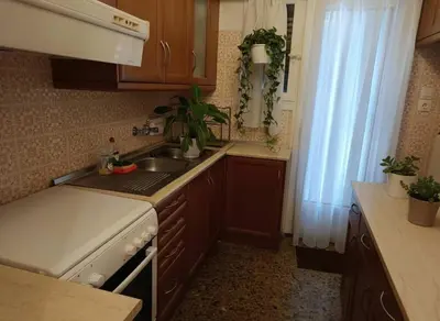 a kitchen with a sink and a stove and a window at Acropolis Vista 3-Bedroom in Neos Kosmos in Athens