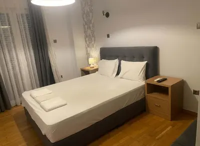 a bedroom with a large bed with white sheets and pillows at The Athenian Nest 2-Bedroom Apartment in Metaxou in Athens
