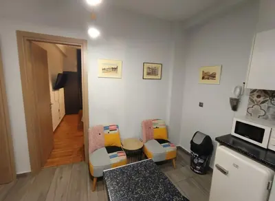 a kitchen with chairs and a table in a room at The Athenian Nest 2-Bedroom Apartment in Metaxou in Athens